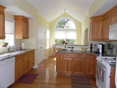 23 Meadowbrook Road Mashpee, MA 02649 - Photo 5 of 20 a kitchen with a sink stove and cabinets