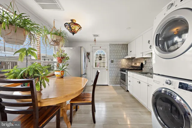 a bedroom with a bed and a dresser next to a window