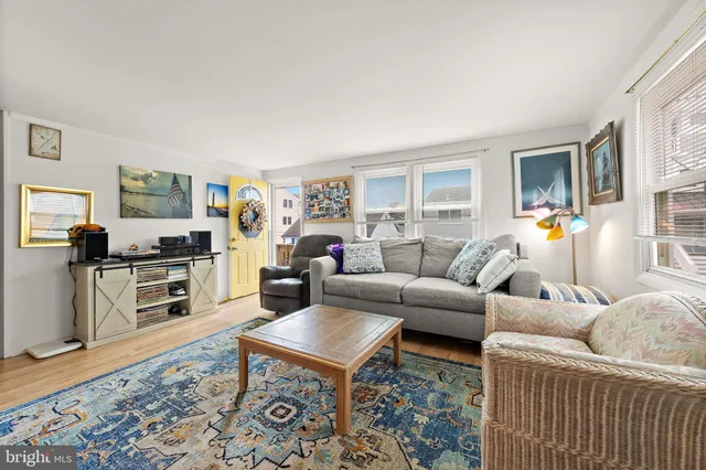 a kitchen with stainless steel appliances granite countertop a dining table chairs refrigerator and sink