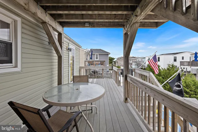 aerial view of a house with balcony and outdoor seating