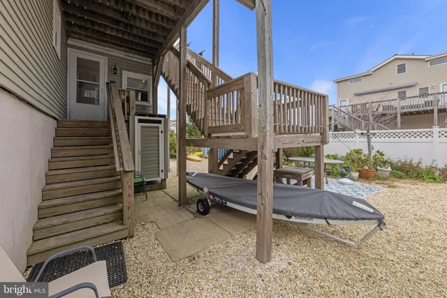 an aerial view of a city with lots of residential buildings and ocean view in back
