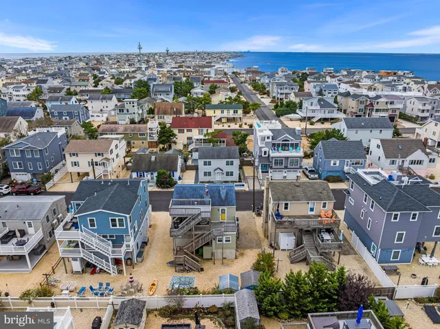 a white house with a yard and plants