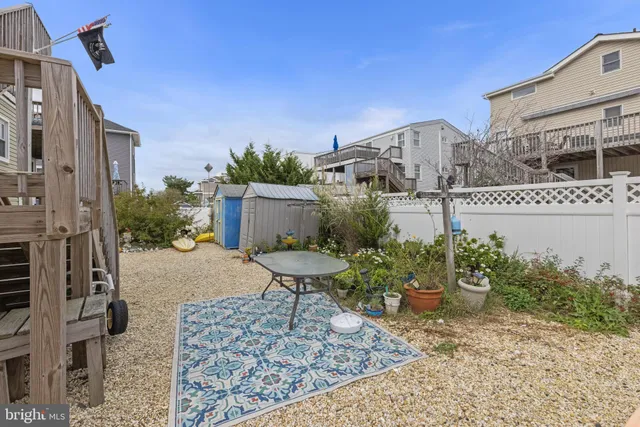 a living room with furniture a bookshelf and a window