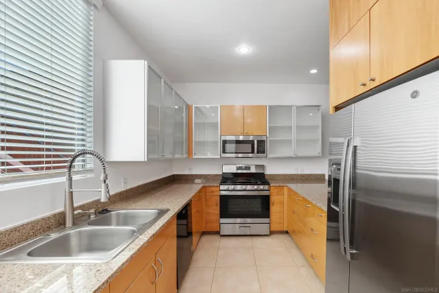 a bathroom with a granite countertop sink toilet and a mirror