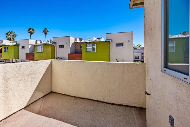 an aerial view of a house with a yard and seating space