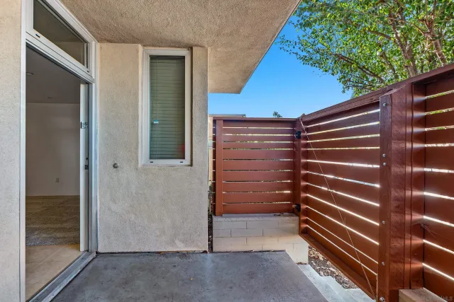 a view of hallway with a couch and wooden floor