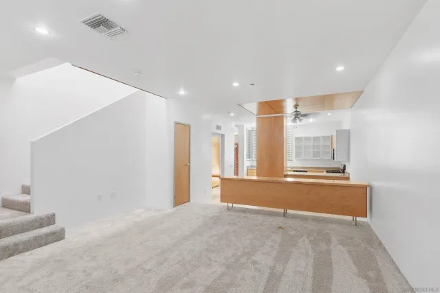 a view of a kitchen with a sink and dishwasher with a dining table