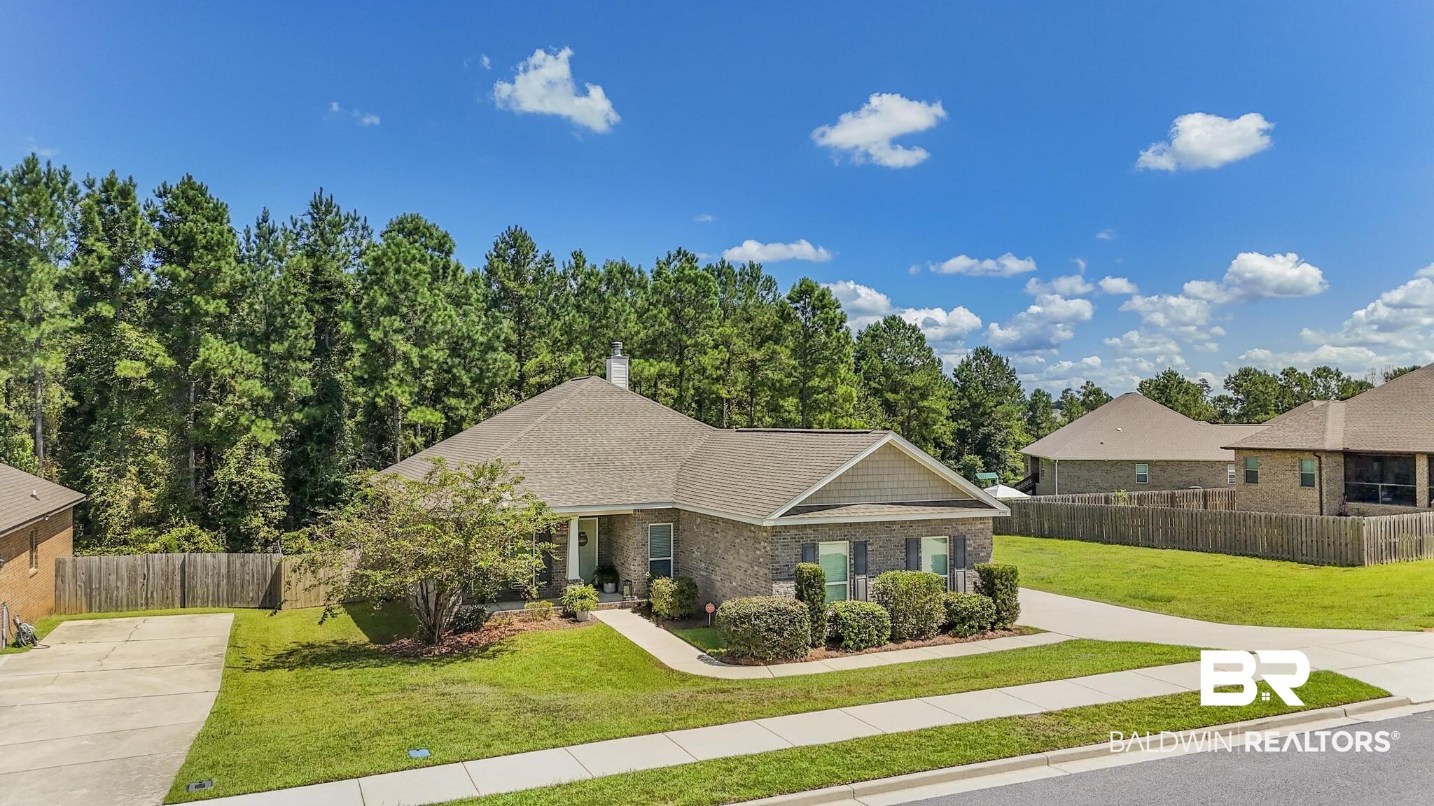31336 Hoot Owl Road Daphne, AL 36527 - Photo 28 of 36 View of front of house with covered porch, a chimney, brick siding, driveway, and roof with shingles