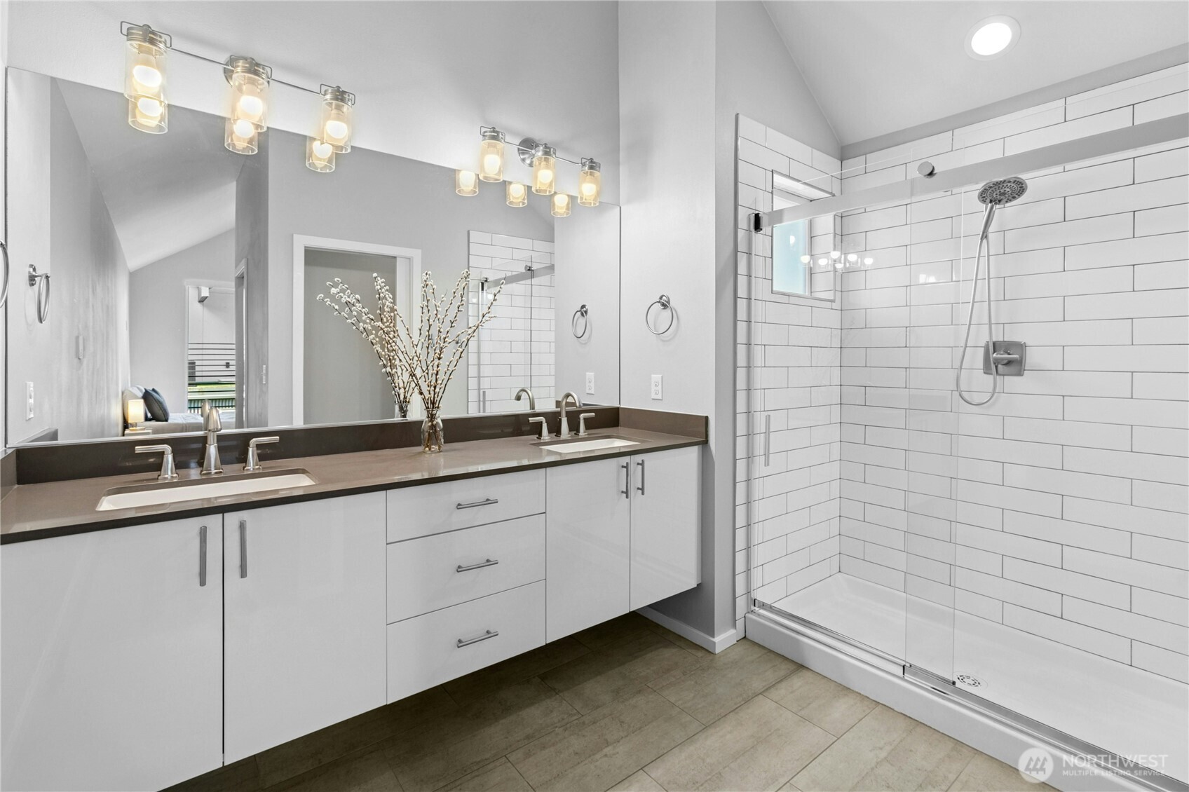 6641 Carleton Avenue South, Unit B Seattle, WA 98108 - Photo 25 of 33 a bathroom with a double vanity sink a large mirror and shower