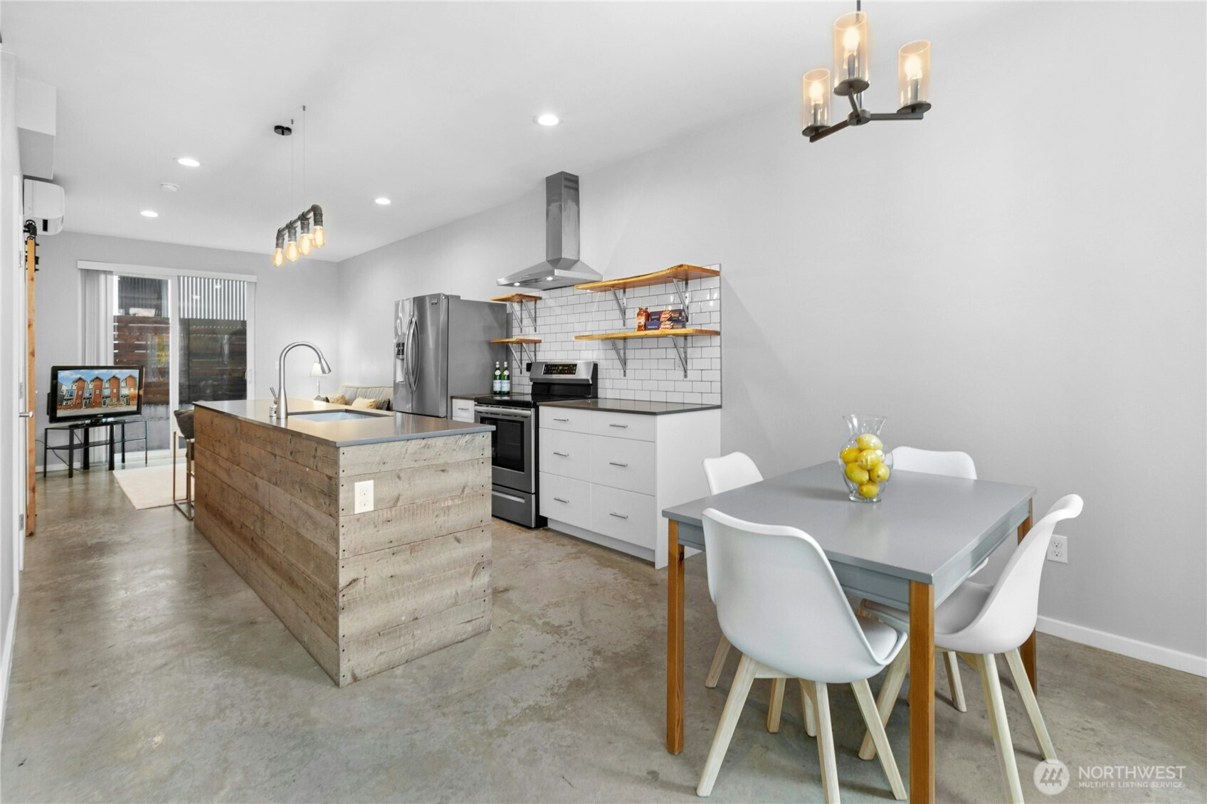 6641 Carleton Avenue South, Unit B Seattle, WA 98108 - Photo 6 of 33 a kitchen with stainless steel appliances kitchen island granite countertop a table chairs and a refrigerator