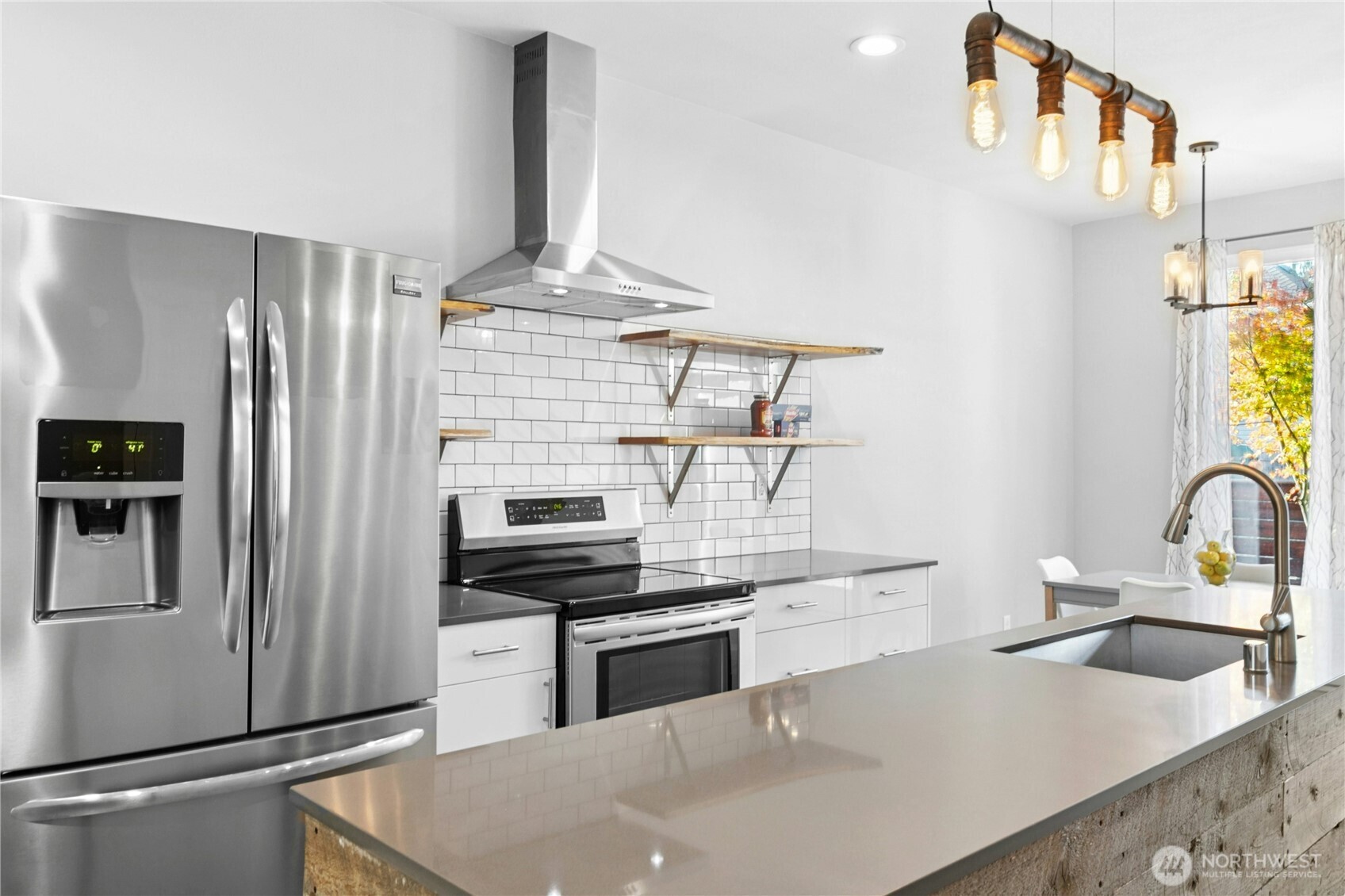 6641 Carleton Avenue South, Unit B Seattle, WA 98108 - Photo 8 of 33 a kitchen with stainless steel appliances a sink a stove and a refrigerator