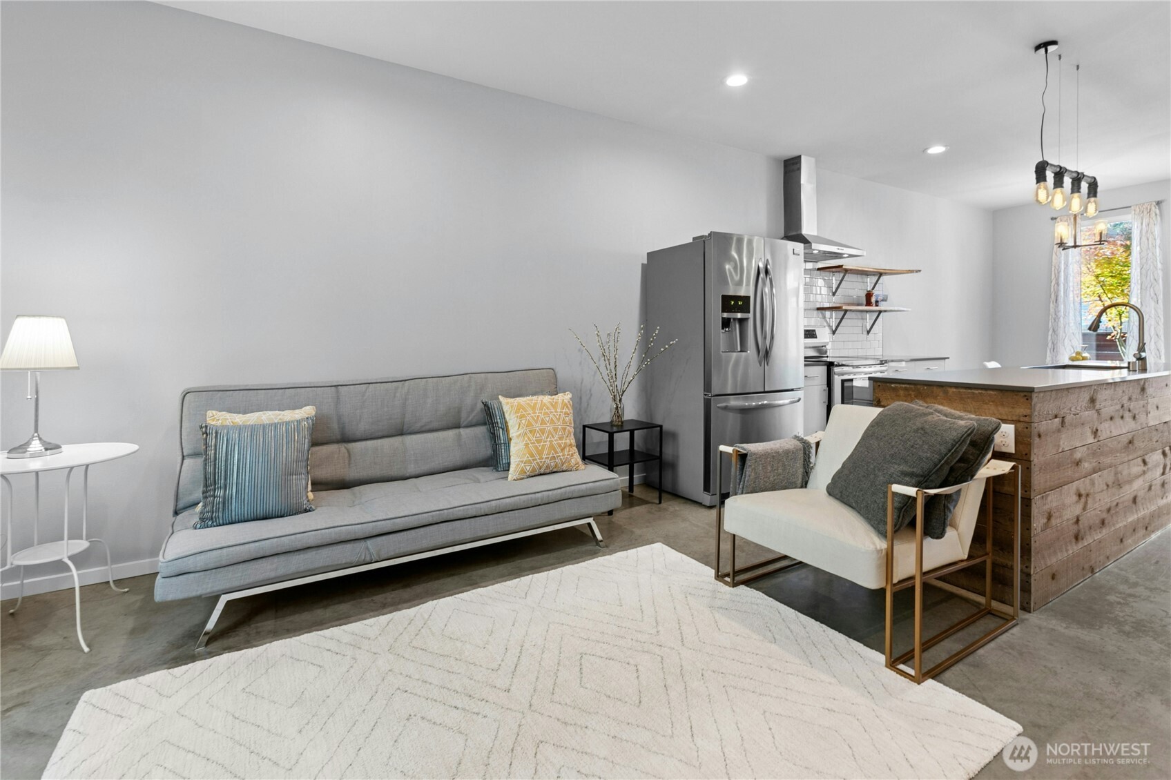 6641 Carleton Avenue South, Unit B Seattle, WA 98108 - Photo 10 of 33 a living room with furniture and a chandelier