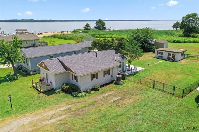 a aerial view of a house with table and chairs plants and large tree