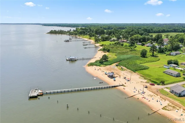 a view of kitchen with microwave oven stove and white cabinets