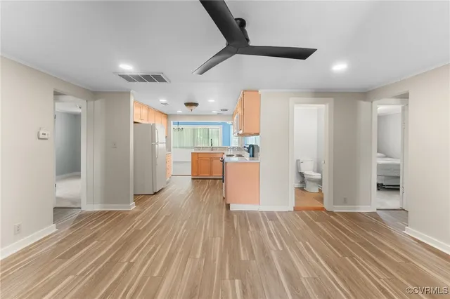 a kitchen with stainless steel appliances granite countertop a stove a sink and white cabinets