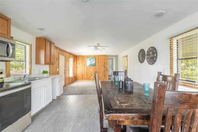 a large kitchen with dining table chairs and chandelier