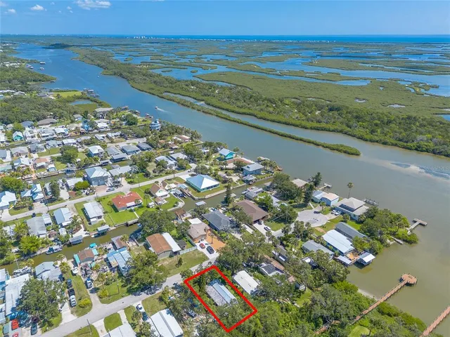 an aerial view of ocean with residential house with outdoor space