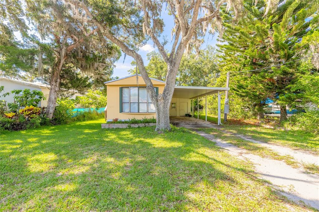 182 Douglas Street Edgewater, FL 32141 - Photo 3 of 30 a view of a house with backyard and a tree