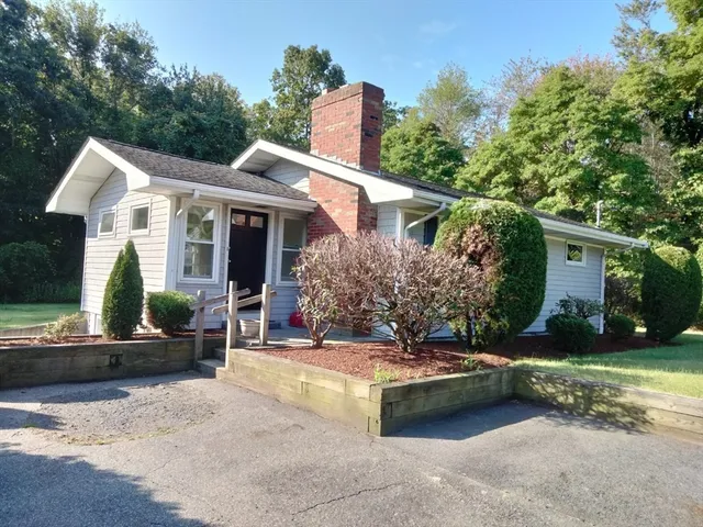 a view of a house with backyard porch and sitting area