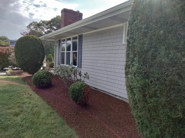 a view of a chair and table in a backyard