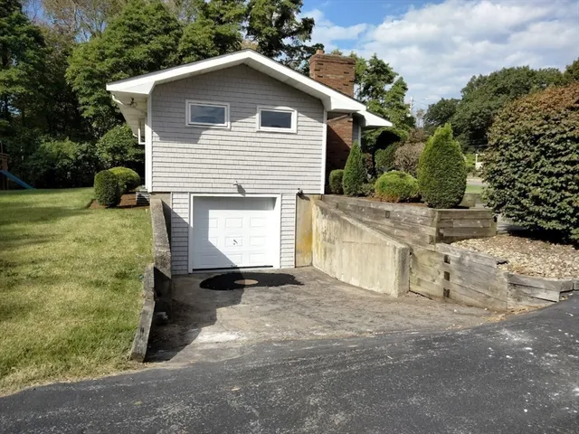 a view of a house with backyard and porch