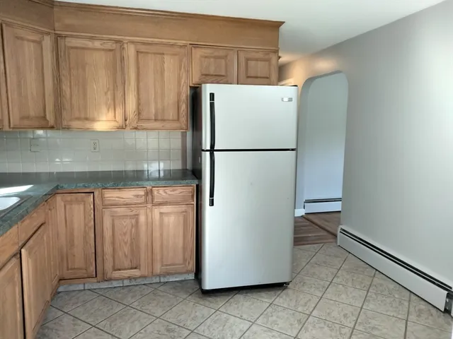 a white refrigerator freezer sitting in a kitchen