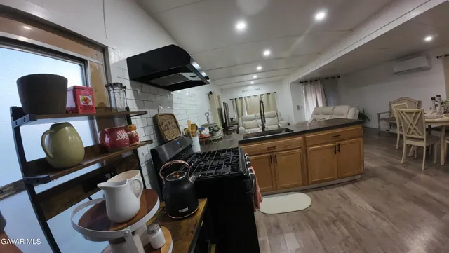 a kitchen with a sink a stove and a microwave