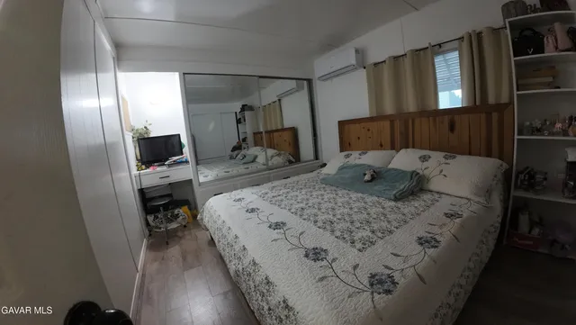 a bed sitting in a bedroom next to a window