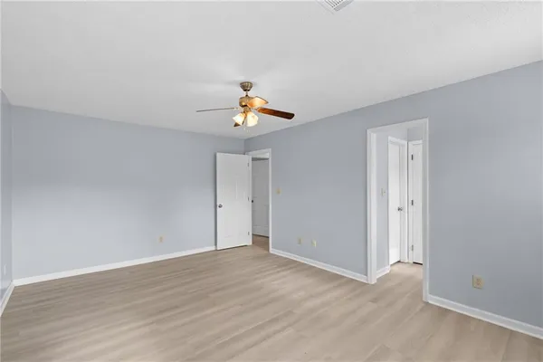 a view of an empty room and wooden floor
