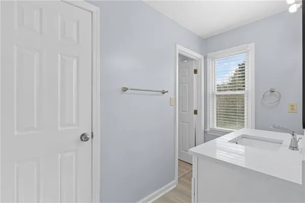 a bathroom with a sink a vanity and a mirror