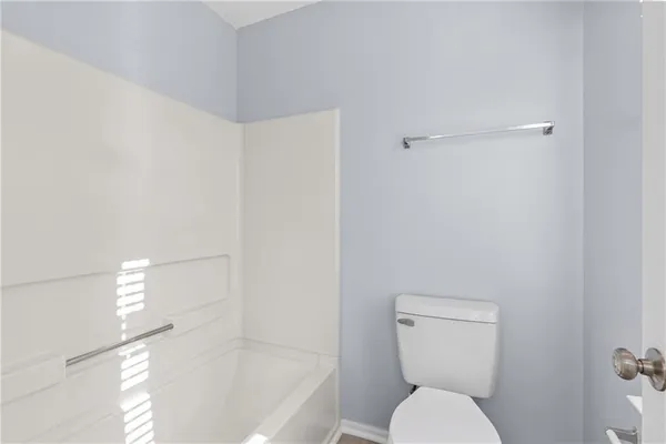 a white toilet sitting next to a bath tub shower
