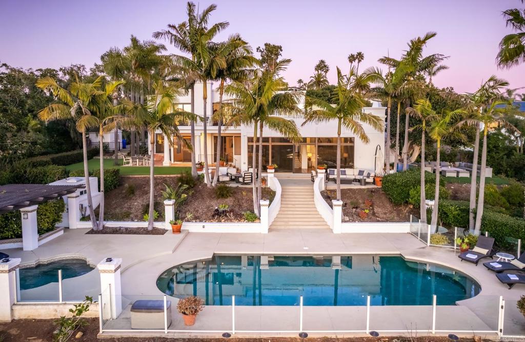 7157 Obelisco Circle Carlsbad, CA 92009 - Photo 1 of 44 a view of multiple houses with a yard and potted plants