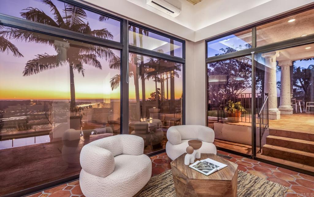 7157 Obelisco Circle Carlsbad, CA 92009 - Photo 21 of 44 a living room with furniture and a floor to ceiling window