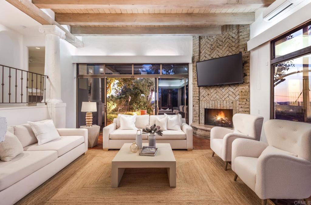 7157 Obelisco Circle Carlsbad, CA 92009 - Photo 23 of 44 a living room with furniture fireplace and a large window