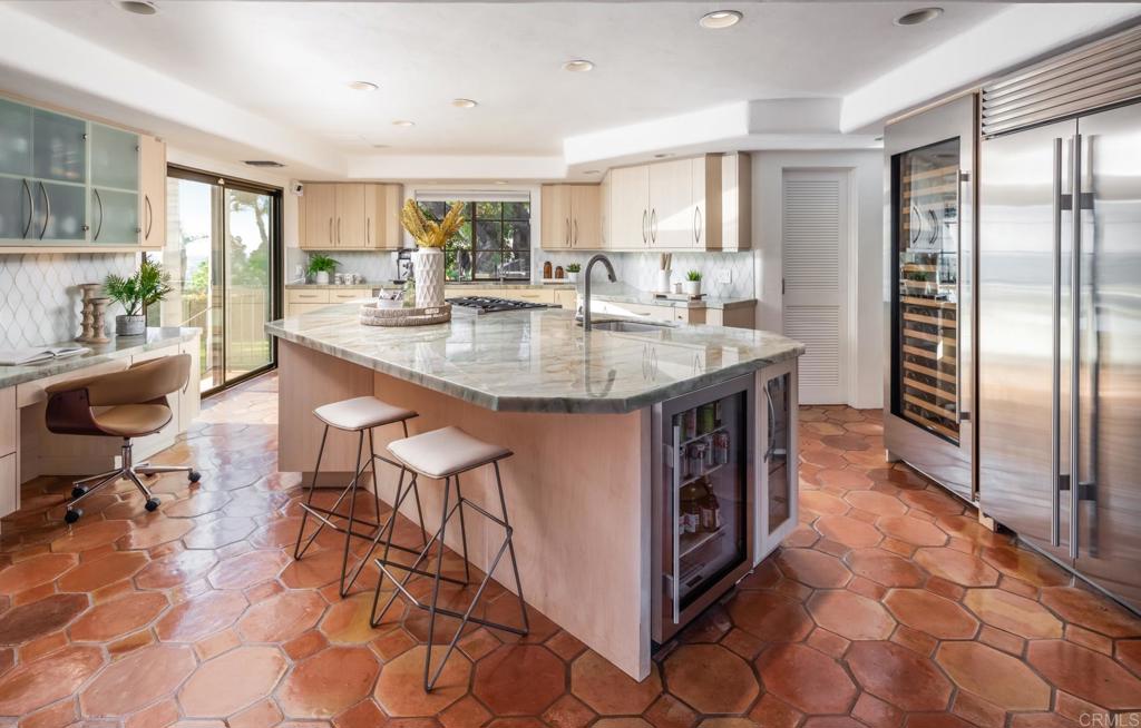 7157 Obelisco Circle Carlsbad, CA 92009 - Photo 24 of 44 a kitchen with stainless steel appliances granite countertop a sink a stove a refrigerator and cabinets