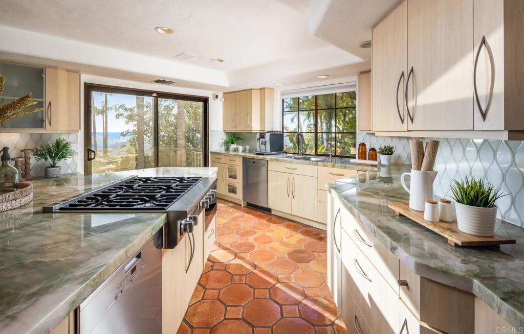 7157 Obelisco Circle Carlsbad, CA 92009 - Photo 25 of 44 a kitchen with a stove and a white cabinets