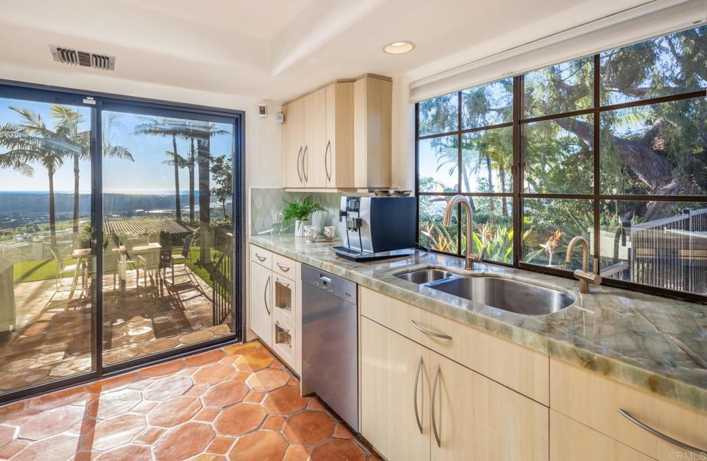 7157 Obelisco Circle Carlsbad, CA 92009 - Photo 26 of 44 a kitchen with a large window and a sink