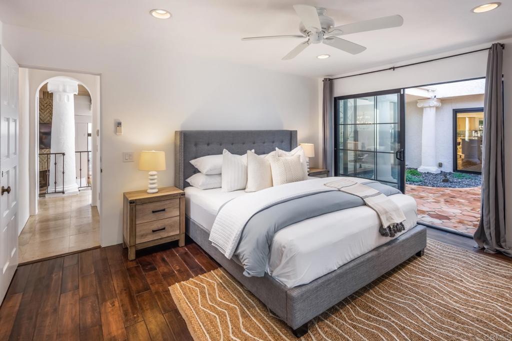 7157 Obelisco Circle Carlsbad, CA 92009 - Photo 31 of 44 a bedroom with bed and wooden floor
