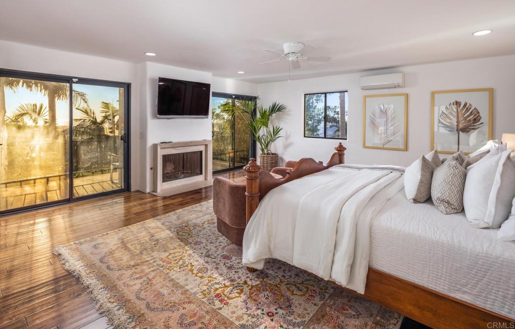 7157 Obelisco Circle Carlsbad, CA 92009 - Photo 34 of 44 a spacious bedroom with a large bed and a flat screen tv