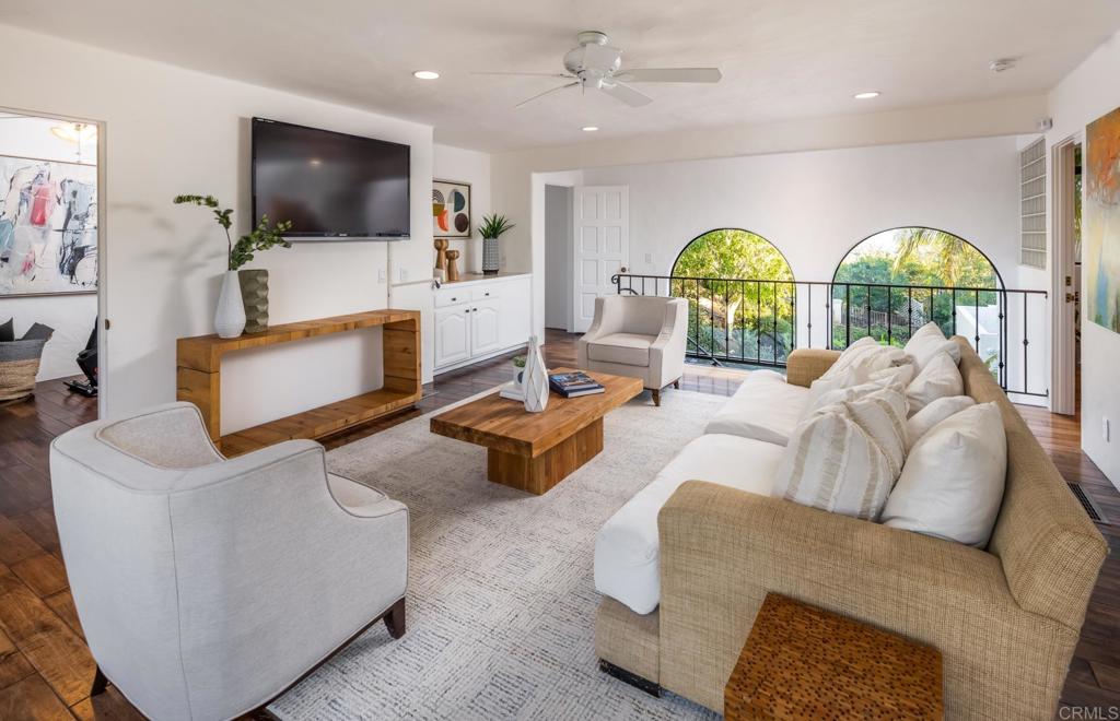7157 Obelisco Circle Carlsbad, CA 92009 - Photo 37 of 44 a living room with furniture a large window and a flat screen tv