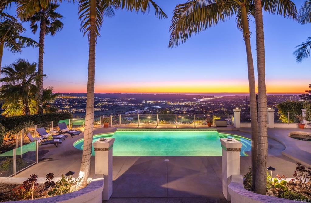 7157 Obelisco Circle Carlsbad, CA 92009 - Photo 7 of 44 a view of a swimming pool with a table and chairs