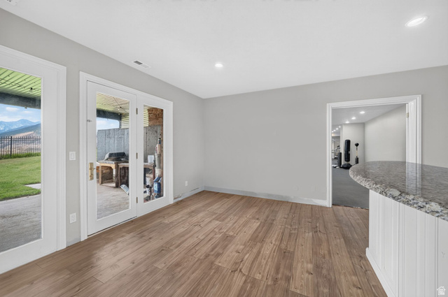 767 Draper View Road Draper, UT 84020 - Photo 40 of 71 Spacious room featuring wood-finish flooring, recessed lighting, and a neutral wall color