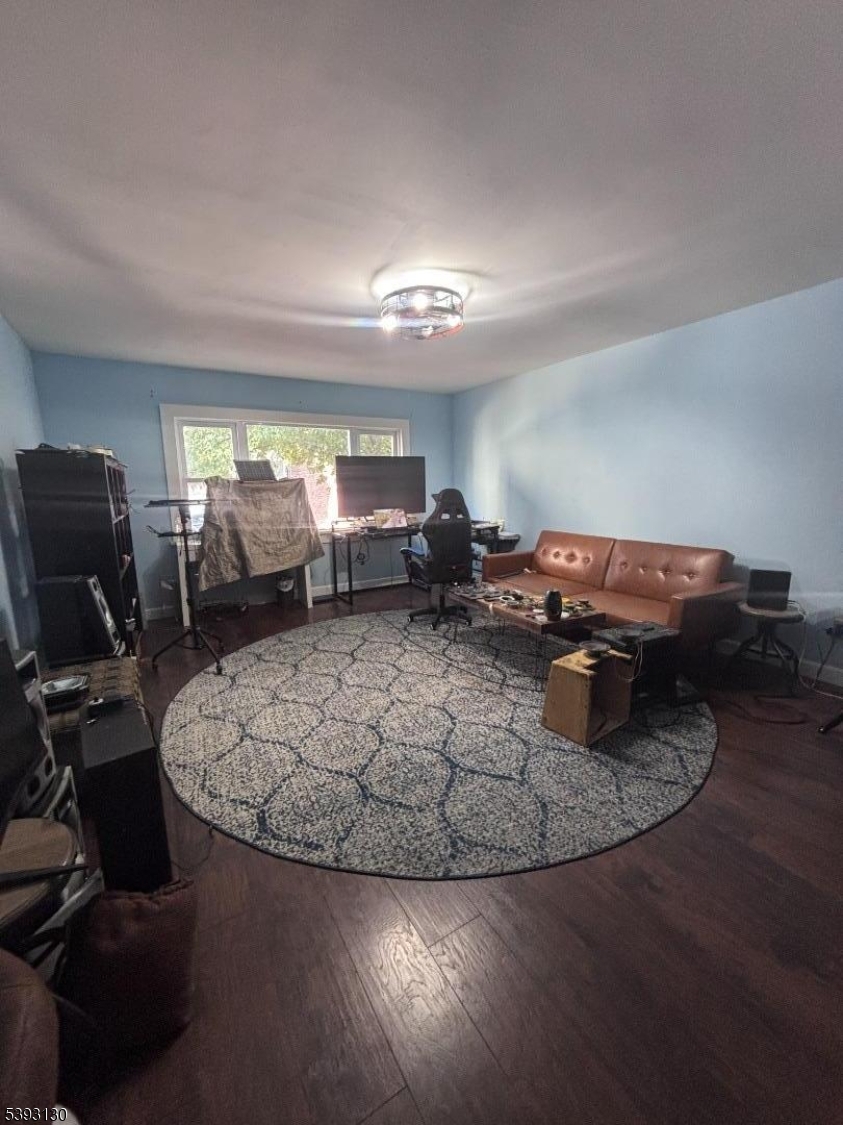 212 4th Street Passaic, NJ 07055 - Photo 3 of 14 a living room with furniture and a flat screen tv
