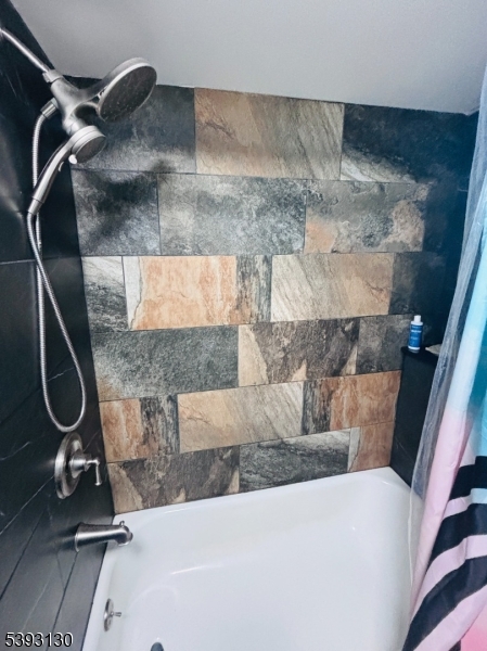 212 4th Street Passaic, NJ 07055 - Photo 8 of 14 a bathroom with a granite countertop sink a mirror and shower