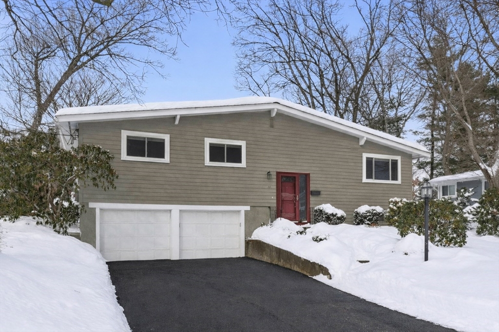 a view of a white house with a yard covered in snow