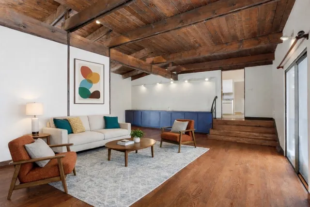 a living room with furniture and wooden floor