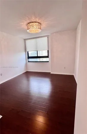 a view of a room with wooden floor and window