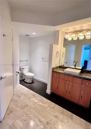 a bedroom with a bed and a large mirror