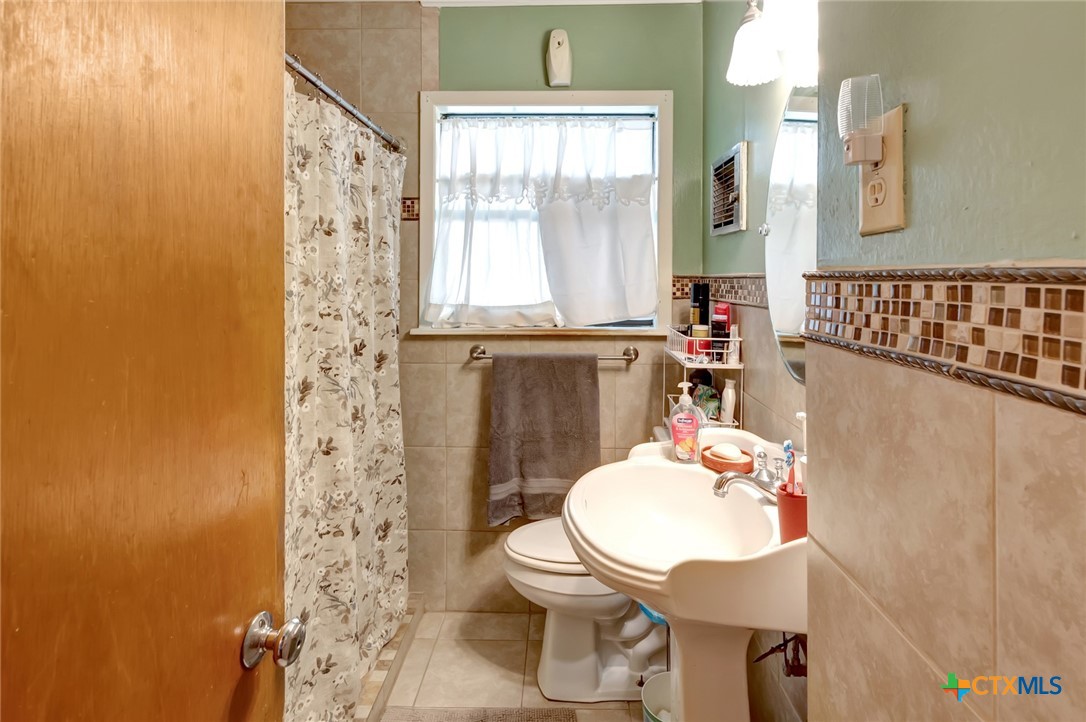 3403 East Rio Grande Street Victoria, TX 77901 - Photo 16 of 41 a bathroom with a sink toilet and a mirror