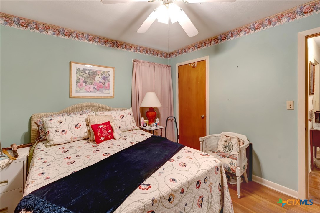 3403 East Rio Grande Street Victoria, TX 77901 - Photo 18 of 41 a bedroom with a bed and wooden floor